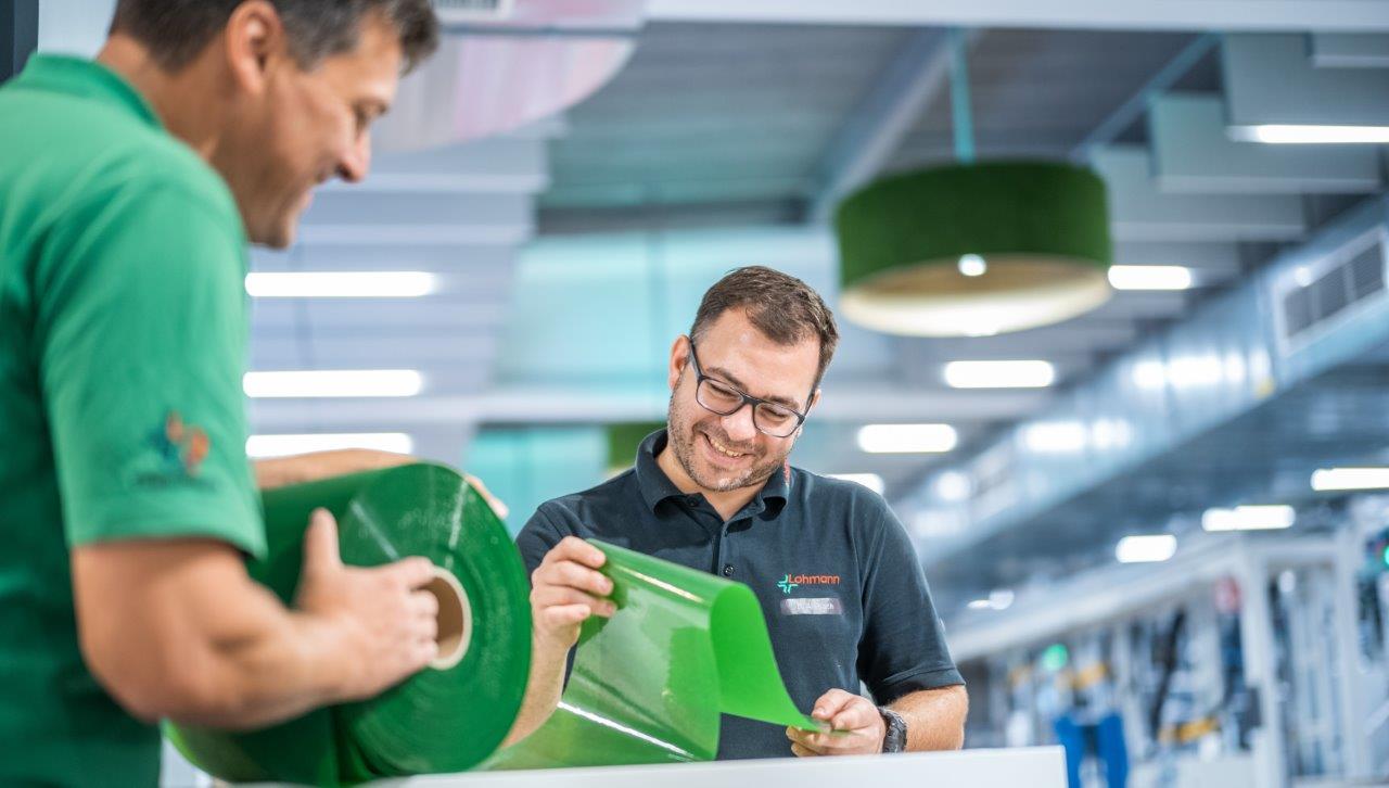 Two Lohmann employees look at the new bio-based ECO-Tape_2.jpg